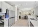 Open kitchen with white cabinets and island at 4734 Tortona Ct, Bradenton, FL 34211