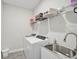 Functional laundry room with washer, dryer, and shelving at 4734 Tortona Ct, Bradenton, FL 34211
