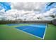 Two well-lit pickleball courts with blue and green surfaces at 4734 Tortona Ct, Bradenton, FL 34211
