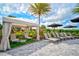 Private poolside cabana with lounge chairs and a small table at 4734 Tortona Ct, Bradenton, FL 34211
