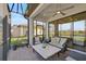 Relaxing screened patio with seating area and pond view at 4734 Tortona Ct, Bradenton, FL 34211