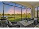 Relaxing screened patio overlooking a pond with seating at 4734 Tortona Ct, Bradenton, FL 34211
