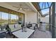 Covered patio with comfortable seating and outdoor grill at 4734 Tortona Ct, Bradenton, FL 34211