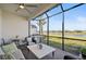Spacious covered patio with seating and water view at 4734 Tortona Ct, Bradenton, FL 34211