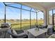 Relaxing screened patio overlooking a pond with seating at 4734 Tortona Ct, Bradenton, FL 34211