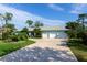 House exterior with a large driveway and lush landscaping at 7917 Broadmoor Pines Blvd, Sarasota, FL 34243