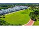 Aerial view of townhouses and a large green space at 2400 Ezzell Ct, Sarasota, FL 34237