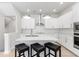 Modern white kitchen with island and stainless steel appliances at 2400 Ezzell Ct, Sarasota, FL 34237