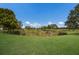 Pond and lush green landscape in community at 2400 Ezzell Ct, Sarasota, FL 34237