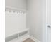 Bright mudroom with built-in bench and hooks at 2400 Ezzell Ct, Sarasota, FL 34237