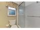 Clean bathroom with shower stall, toilet, and window at 444 Bellini Cir, Nokomis, FL 34275