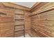 Large walk-in cedar closet with built in shelves and hanging rods at 444 Bellini Cir, Nokomis, FL 34275