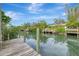 Wooden dock extends over calm canal waters, offering peaceful waterfront views at 444 Bellini Cir, Nokomis, FL 34275