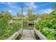 Wooden dock offering water access and lush greenery at 444 Bellini Cir, Nokomis, FL 34275