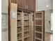 Walk-in pantry with wooden shelving provides ample storage space at 444 Bellini Cir, Nokomis, FL 34275