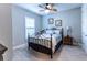 Light and airy bedroom with a ceiling fan and window shutters at 4747 Motta Ct, Bradenton, FL 34211