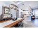 Elegant dining room with a long wooden table and modern chandelier at 4747 Motta Ct, Bradenton, FL 34211