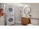 Clean bathroom with walk-in shower, modern vanity, and stacked washer/dryer at 5610 Avenida Del Mare, Sarasota, FL 34242