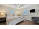 Comfortable bedroom with a king-size bed and a ceiling fan at 5610 Avenida Del Mare, Sarasota, FL 34242