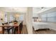 Dining area and bedroom with wooden floors and a ceiling fan at 5610 Avenida Del Mare, Sarasota, FL 34242