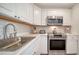 Modern kitchen with white cabinets, stainless steel appliances, and marble counters at 5610 Avenida Del Mare, Sarasota, FL 34242