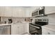 Well-equipped kitchen featuring white shaker cabinets and stainless steel appliances at 5610 Avenida Del Mare, Sarasota, FL 34242