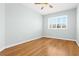 Well-lit bedroom featuring hardwood floors and window shutters at 7914 Grand Estuary Trl # 102, Bradenton, FL 34212