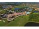 Aerial view of community clubhouse near golf course and tennis courts at 7914 Grand Estuary Trl # 102, Bradenton, FL 34212