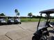 Golf carts parked near a golf course at 7914 Grand Estuary Trl # 102, Bradenton, FL 34212