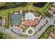 Overhead view of community pool, tennis courts, and clubhouse at 11192 Whimbrel Ln, Sarasota, FL 34238