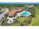 Community pool and clubhouse with surrounding landscape at 11192 Whimbrel Ln, Sarasota, FL 34238
