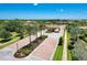 Gated community entrance with lush landscaping and palm trees at 11192 Whimbrel Ln, Sarasota, FL 34238