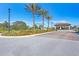 Gated community entrance with landscaping and lighting at 11192 Whimbrel Ln, Sarasota, FL 34238