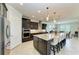 Spacious kitchen with island, granite counters, and stainless steel appliances at 11192 Whimbrel Ln, Sarasota, FL 34238