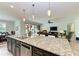 Open concept kitchen with island, granite counters, and stainless steel appliances at 11192 Whimbrel Ln, Sarasota, FL 34238