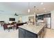 Open concept kitchen with island, granite counters, and living room view at 11192 Whimbrel Ln, Sarasota, FL 34238