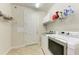Laundry room with washer, dryer, and storage shelves at 11192 Whimbrel Ln, Sarasota, FL 34238