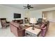 Relaxing living room with leather furniture and a large TV at 11192 Whimbrel Ln, Sarasota, FL 34238