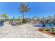 Outdoor kitchen and seating area with grills and a fire pit at 11192 Whimbrel Ln, Sarasota, FL 34238