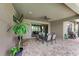 Covered patio with outdoor dining furniture and ceiling fan at 11192 Whimbrel Ln, Sarasota, FL 34238