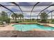 Freeform pool and spa with screened enclosure and brick patio at 11192 Whimbrel Ln, Sarasota, FL 34238