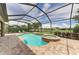 Freeform pool and spa with screened enclosure and brick patio at 11192 Whimbrel Ln, Sarasota, FL 34238