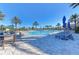 Community pool with lounge chairs and patio tables at 11192 Whimbrel Ln, Sarasota, FL 34238