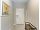 Bright entryway with tiled floors, bench, and sunflower art at 14607 Barefoot Ln, Parrish, FL 34219
