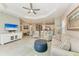 Open living space with comfortable seating, large TV, and view into kitchen at 14607 Barefoot Ln, Parrish, FL 34219