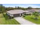 Single-story home with a large backyard and a paved driveway at 1478 Navigator Rd, Punta Gorda, FL 33983
