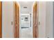 View of hallway leading to double-door closets and bathroom at 1478 Navigator Rd, Punta Gorda, FL 33983