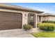 Front view of home with brown garage door and entryway at 1478 Navigator Rd, Punta Gorda, FL 33983