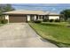 Single story home with brown garage door and well-maintained lawn at 1478 Navigator Rd, Punta Gorda, FL 33983