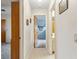 Hallway with light walls, tile flooring, and doors to bedrooms at 1478 Navigator Rd, Punta Gorda, FL 33983